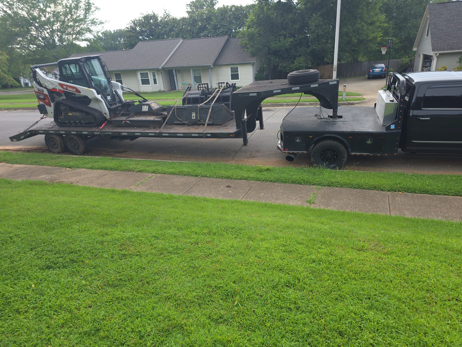 Bobcat T66 and attachments on a gooseneck trailer